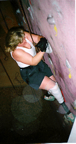 Gracie climbing a rock wall